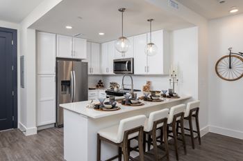 Modern white kitchen with island and pendant lighting